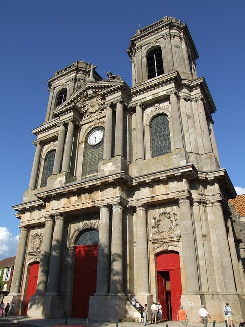 Langres Cathedral two towers clock in center and red doors